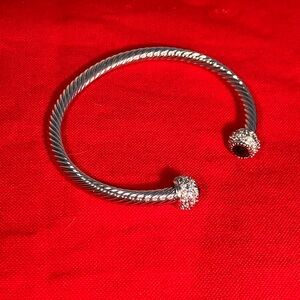 This cuff bracelet is inspired by a Yurman design. With clear and jet end caps.